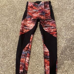 Cute high rise, full length Lululemon leggings with sections of pink pattern.